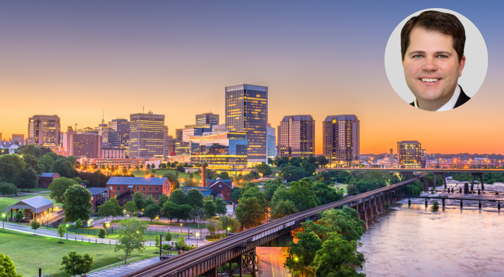 Headshot of Richmond litigator John M. Erbach with the Richmond skyline in the background